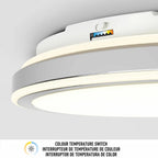 Modern white dimmable LED ceiling light fixture with color temperature switch indicator label, mounted flush against gray cei