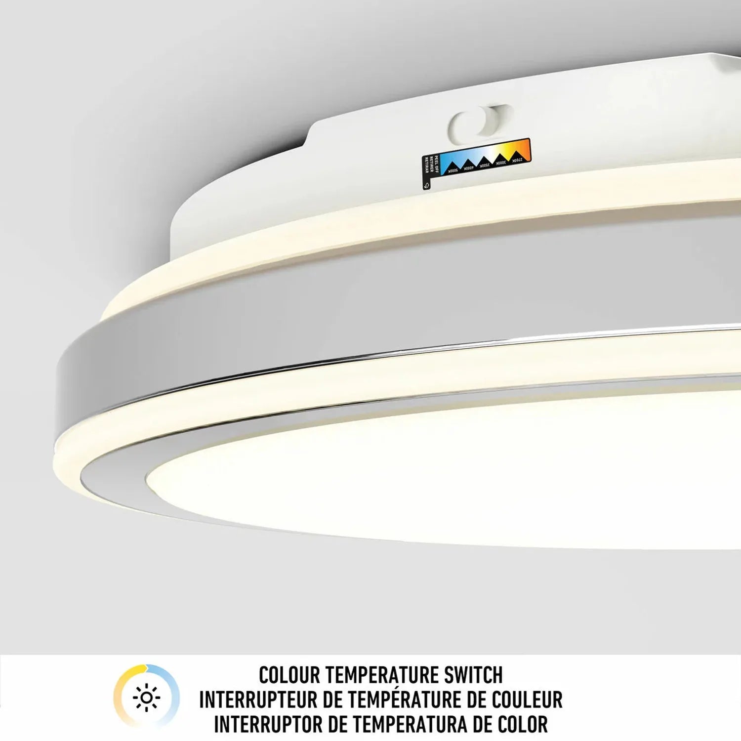 Modern white dimmable LED ceiling light fixture with color temperature switch indicator label, mounted flush against gray cei
