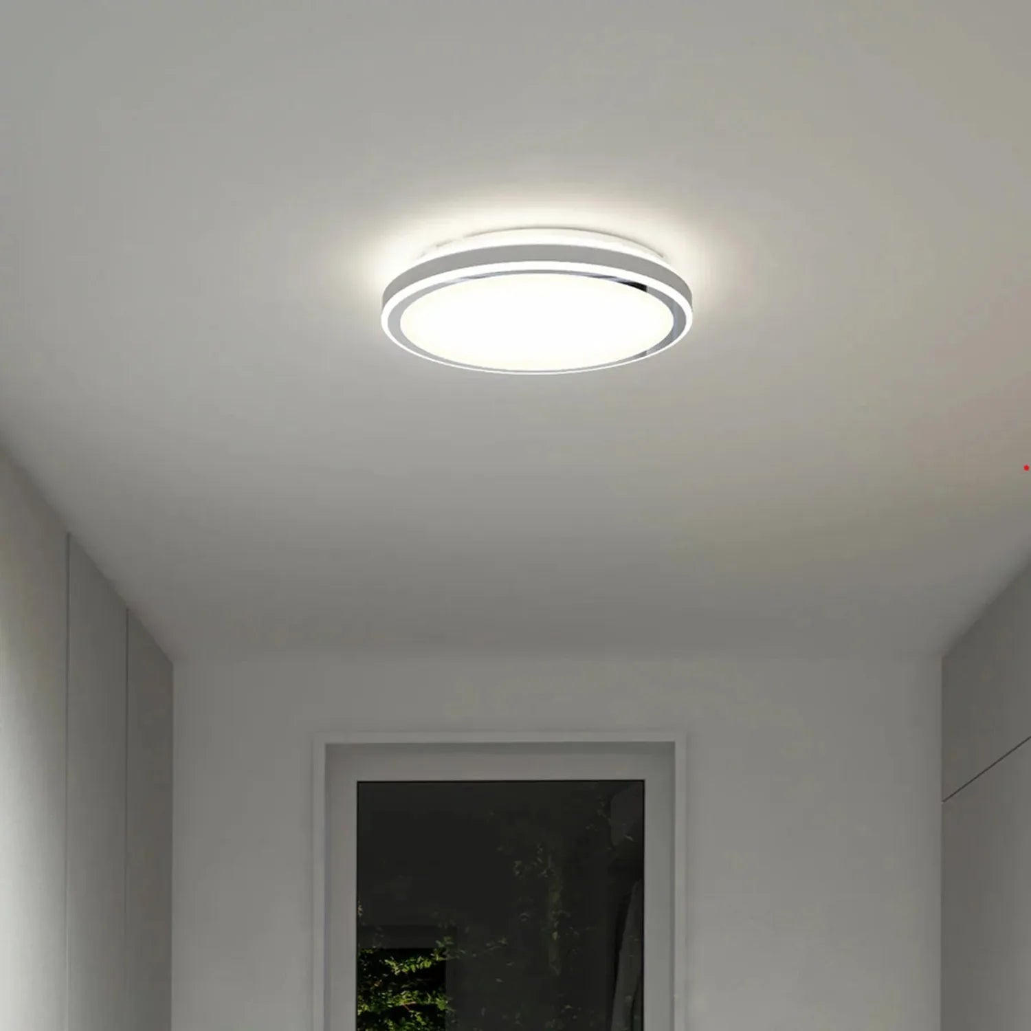Artika Altitude LED ceiling light installed in hallway, emitting bright white light from circular fixture with chrome trim ri