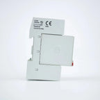 White modular surge protector with open access panel showing internal components and CE IP20 certification label on top.