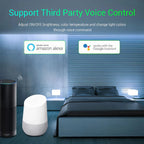Bedroom scene showing Amazon Alexa speaker and Google Assistant device with white smart lamp, demonstrating voice control com
