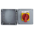 Two-part product view showing empty gray housing on left and assembled red and yellow rotary disconnect switch with specifica