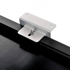 Silver aluminum Z-bracket with mounting holes and stainless steel bolt, installed on black rail for solar panel mounting.