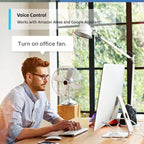 Man at office desk with smart plug-controlled desk lamp and fan, demonstrating voice command "Turn on office fan" with Amazon