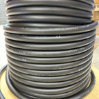 Coiled gray electrical cable with printed specifications, showing Helukabel branding and certification marks on multiple loop