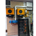 Solar inverter installation showing two orange Voltacon units mounted on wall above blue battery components and black cabinet