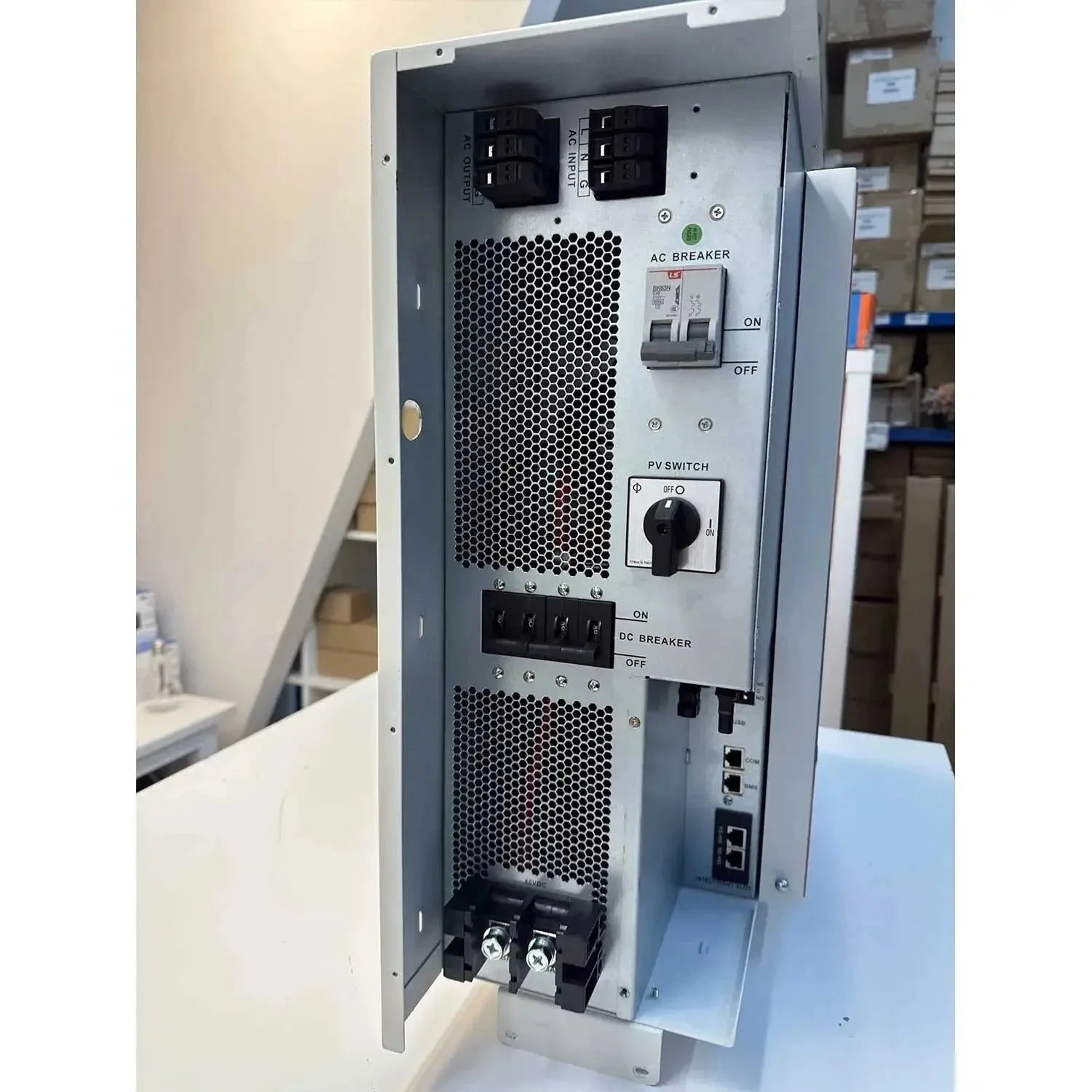 Voltasol ESS 5500W Hybrid Inverter Charger mounted on wall showing AC breaker, PV switch, DC breaker controls and ventilation