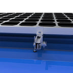 Solar panel mounting clamp installed on blue corrugated roof with black solar panels visible above.