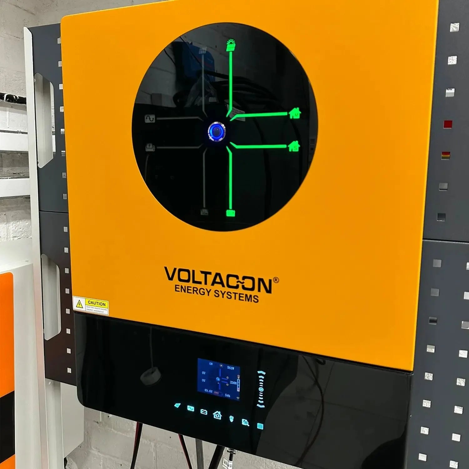 Voltagon Energy Systems 11kW inverter mounted on yellow panel with illuminated green schematic display and control interface 