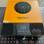 Voltacon Energy Systems inverter with orange top panel and black housing, displaying green wiring diagram on screen and monit
