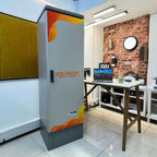 Voltacon Energy Systems battery enclosure installed in an office showroom with exposed brick wall and work desk.