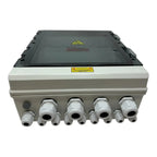 Solar PV combiner box with gray enclosure, black hinged top panel, yellow hazard warning labels, and eight white cable connec