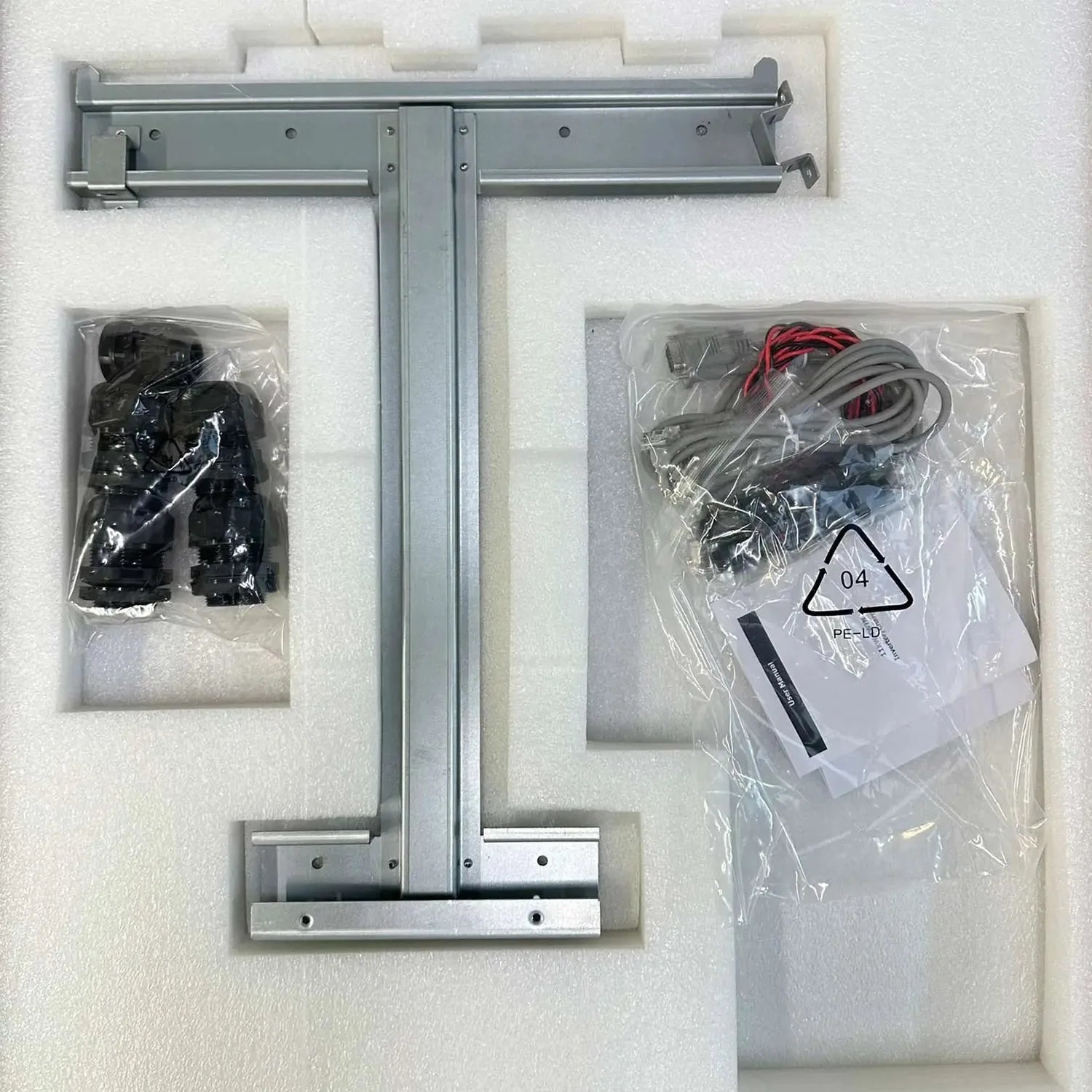 Unboxed inverter components showing metal mounting frame, black plastic connectors, and wired electrical assembly labeled PE-