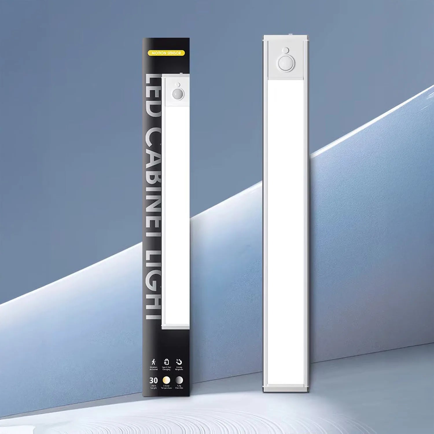 Two white motion sensor LED under cabinet lights displayed next to black product packaging against blue background.