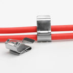 Stainless steel solar panel cable clips securing red cables, showing one attached and one detached unit on white background.