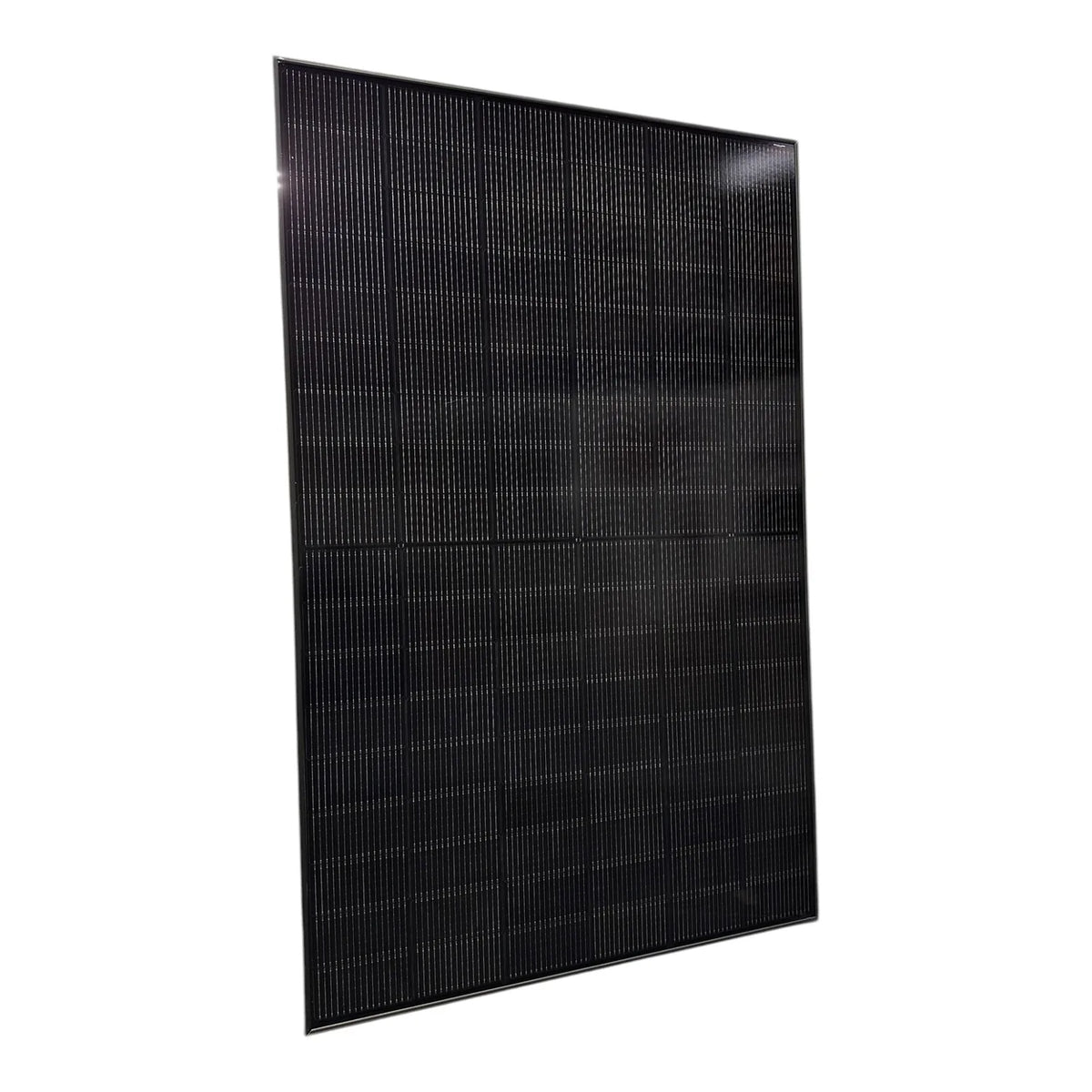 Black monocrystalline solar panel tilted at an angle against white background, showing grid of photovoltaic cells.