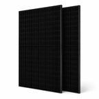 Two black monocrystalline solar panels standing upright at an angle, product photography on white background.