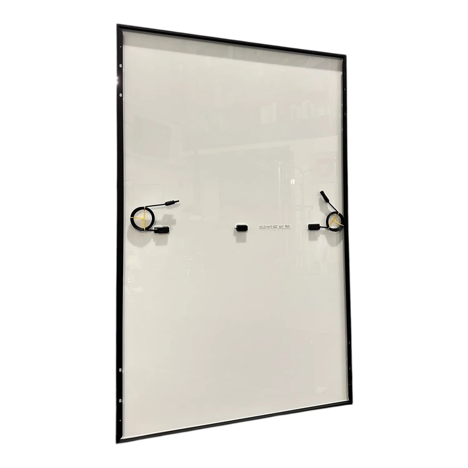 Solar panel with black frame mounted at angle, showing two micro inverters and wiring hardware attached to white surface.