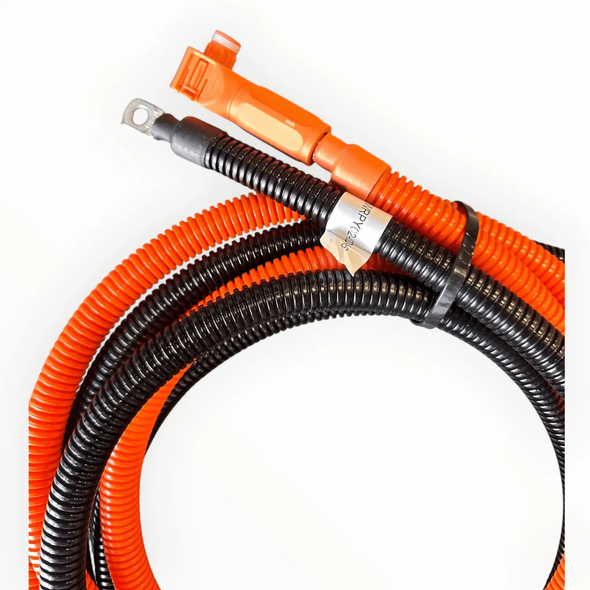 Coiled orange and black battery extension cable with connectors at one end and a white label band, displayed against white ba