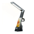 Black LED desk lamp with integrated wireless charging pad, phone holder, and digital display showing 09:00, product shot on w