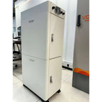 Voltagon white lithium battery cabinet with two stacked modules and control panel on top, displayed in showroom setting.