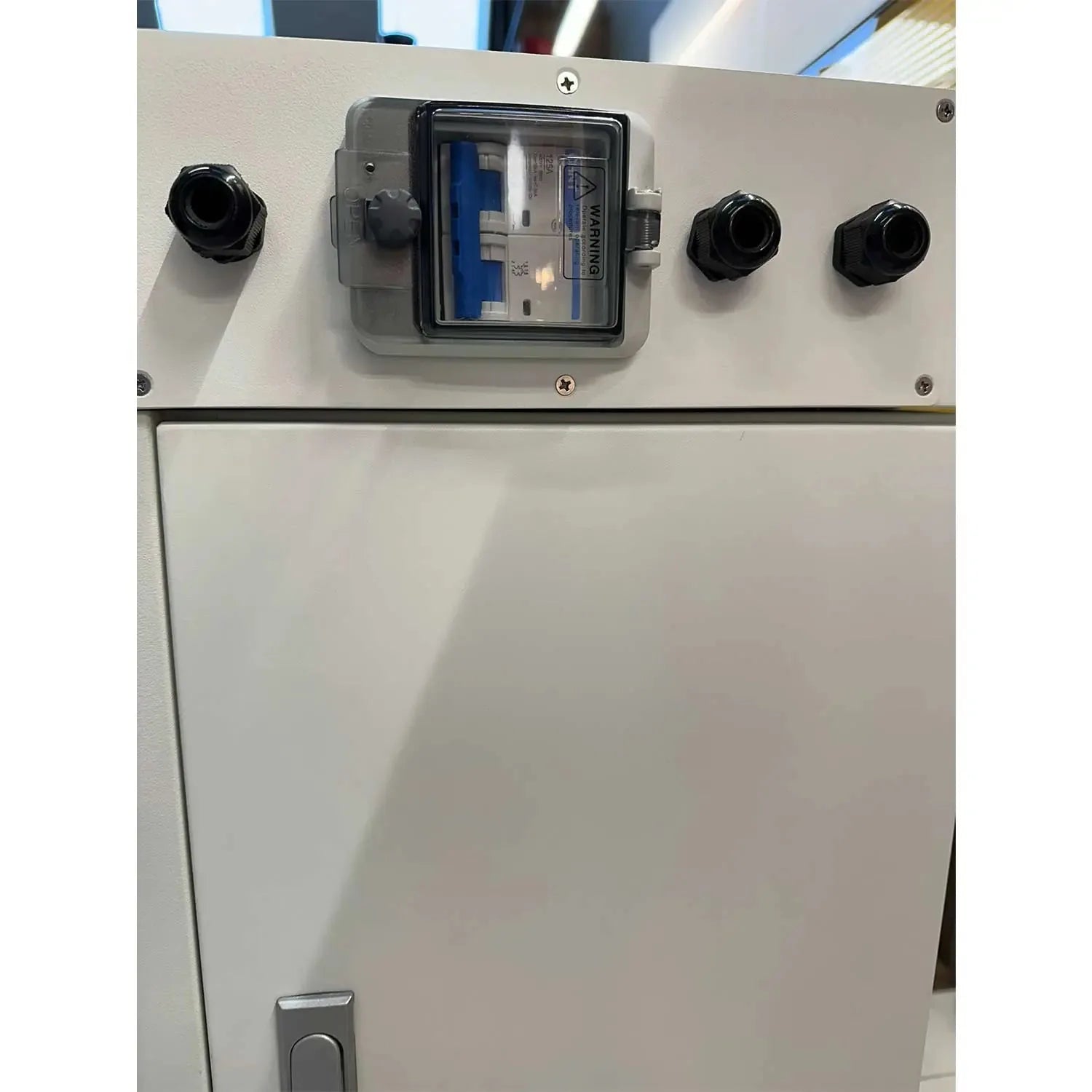 White lithium battery cabinet control panel with three black cable entry ports, central display window, and lower access door