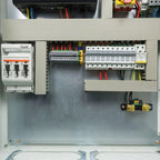 Open electrical cabinet showing 48V inverter charger system with circuit breakers, terminal blocks, and wiring installation.