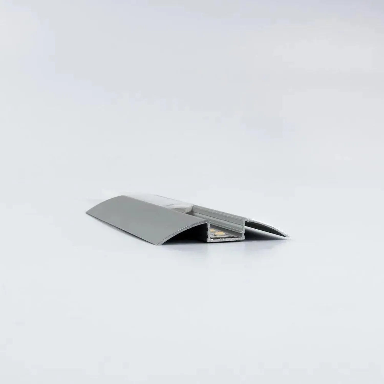 Silver aluminum LED profile extrusion with frosted diffuser cover, shown open to reveal internal channel against white backgr