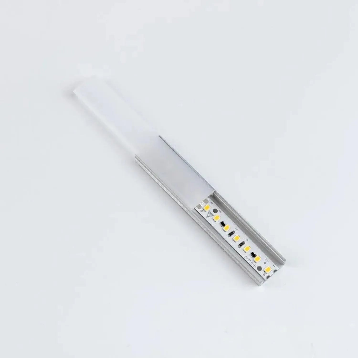 Aluminium LED profile U channel with integrated white diffuser cover and yellow LED chips mounted on white PCB, shown at angl