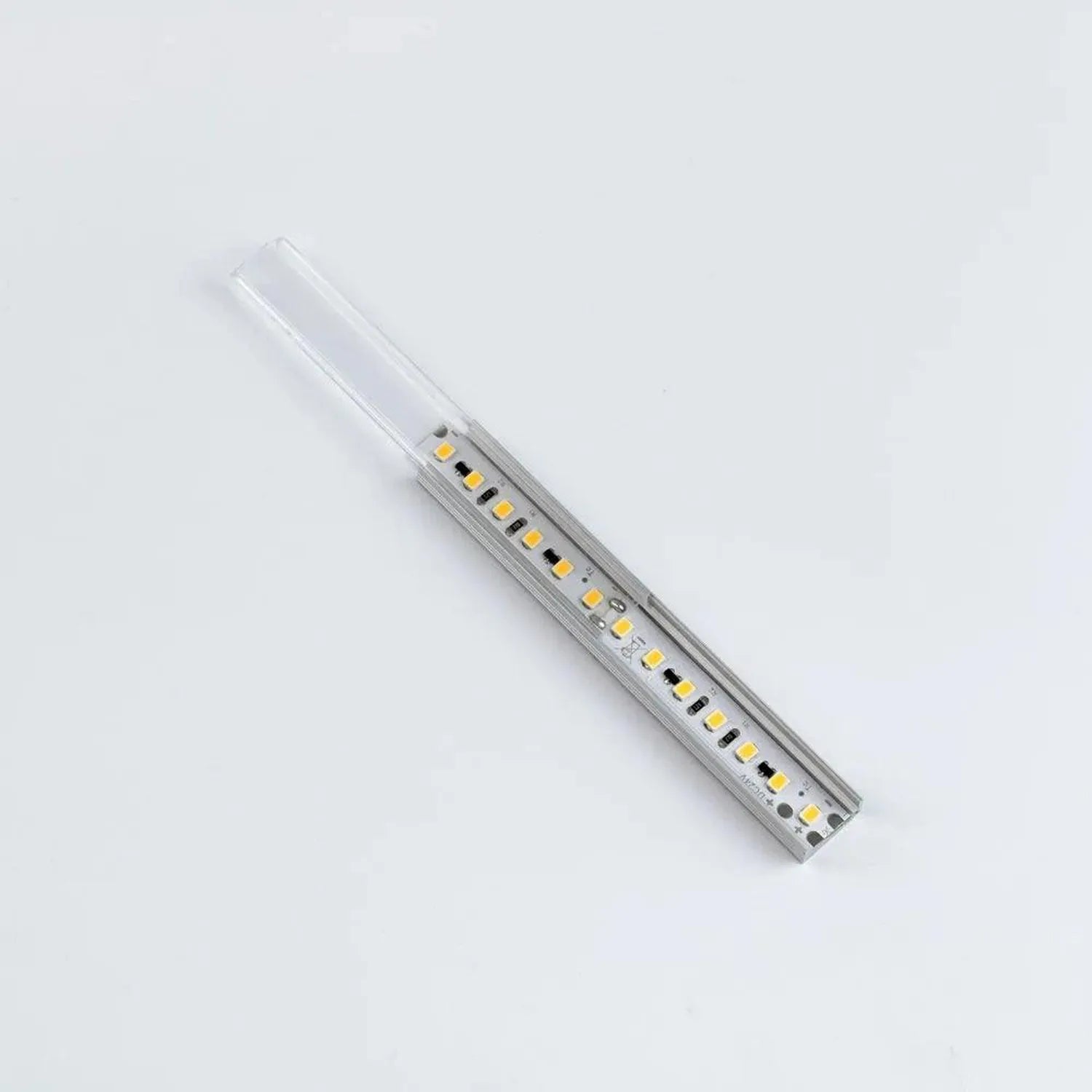 Aluminium LED profile with integrated diffuser strip showing yellow LED diodes mounted on silver metal channel, displayed aga