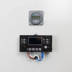 Victron Energy battery monitor mounted above black inverter charger cabinet with digital display, control buttons, and blue p