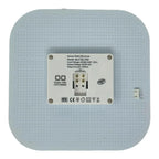 Back view of sensor-controlled 2D LED lamp showing terminal block connections and specifications label, mounted on perforated