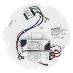 Internal components of LED retrofit fitting showing driver modules, wiring, and terminal blocks mounted on white circular bas