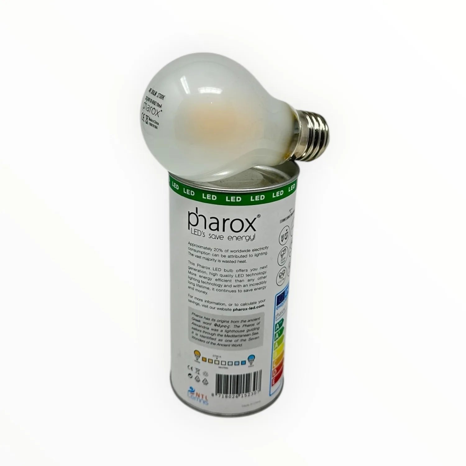 Pharox LED bulb with frosted glass globe sitting atop its cylindrical packaging box labeled "LEDs save energy