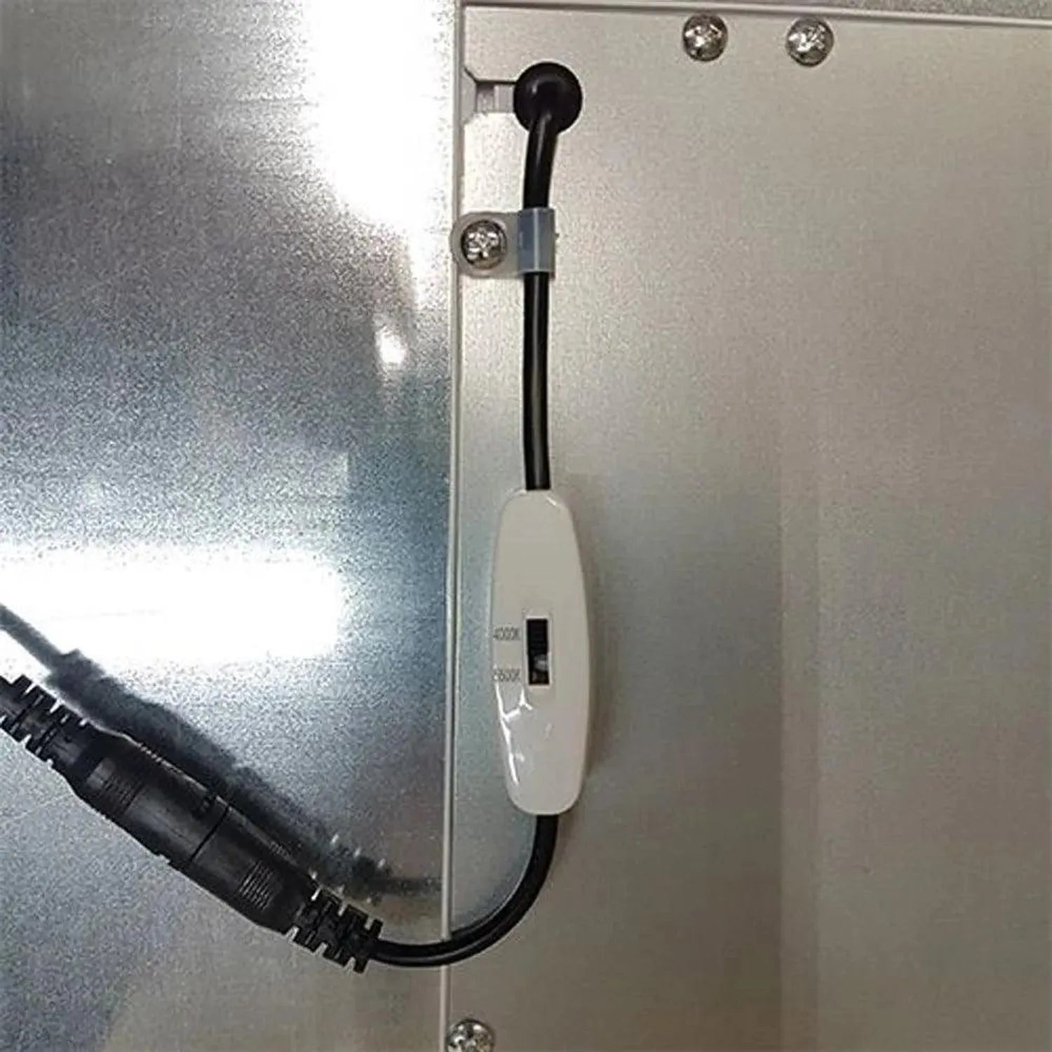 LED panel light mounted on wall with power cord attached and integrated switch control visible.