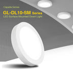 Glacial GL-DL10-SM Series LED surface mounted downlight with white round bezel shown installed on ceiling alongside two small