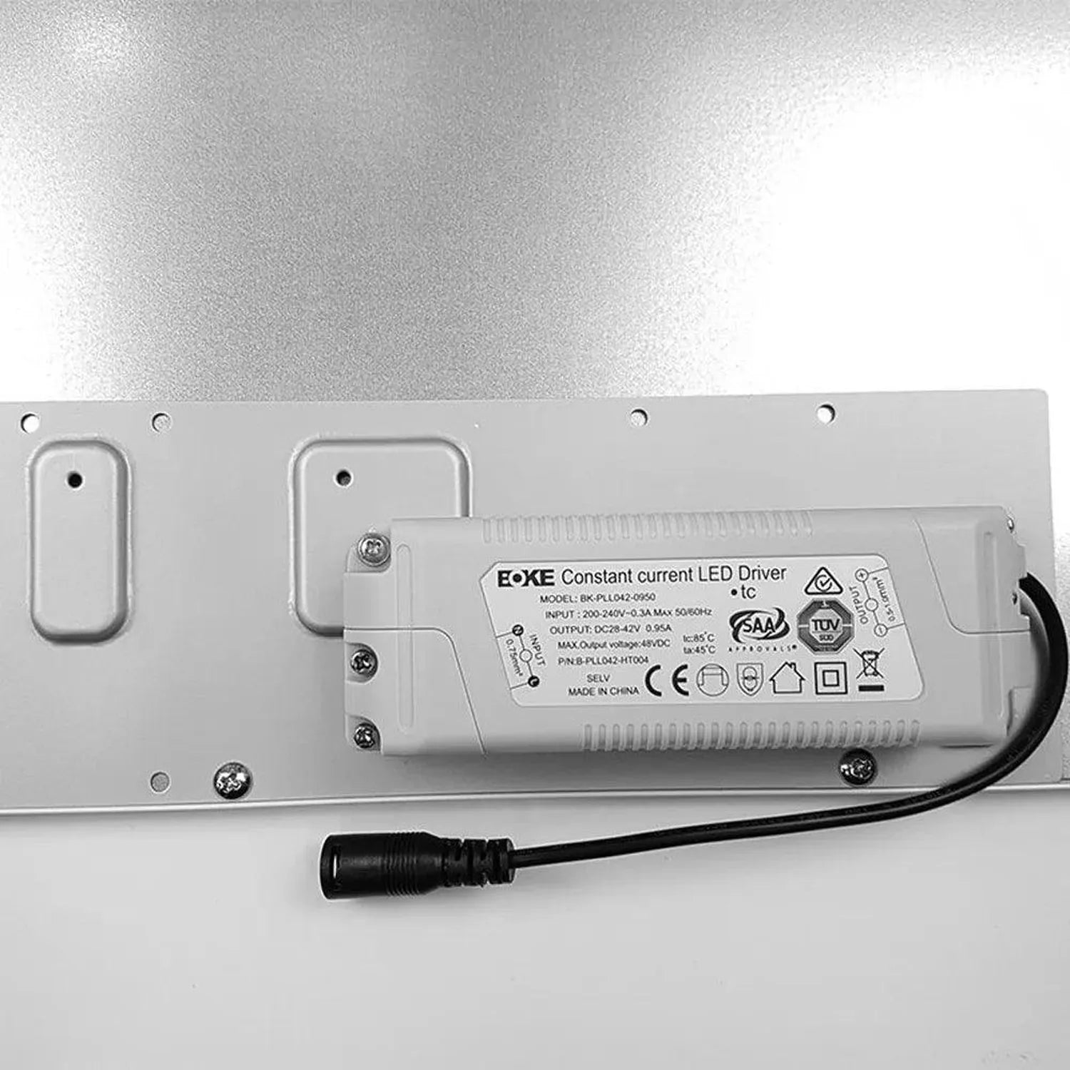 EoKE constant current LED driver mounted on white metal rail with black power cable connector visible.