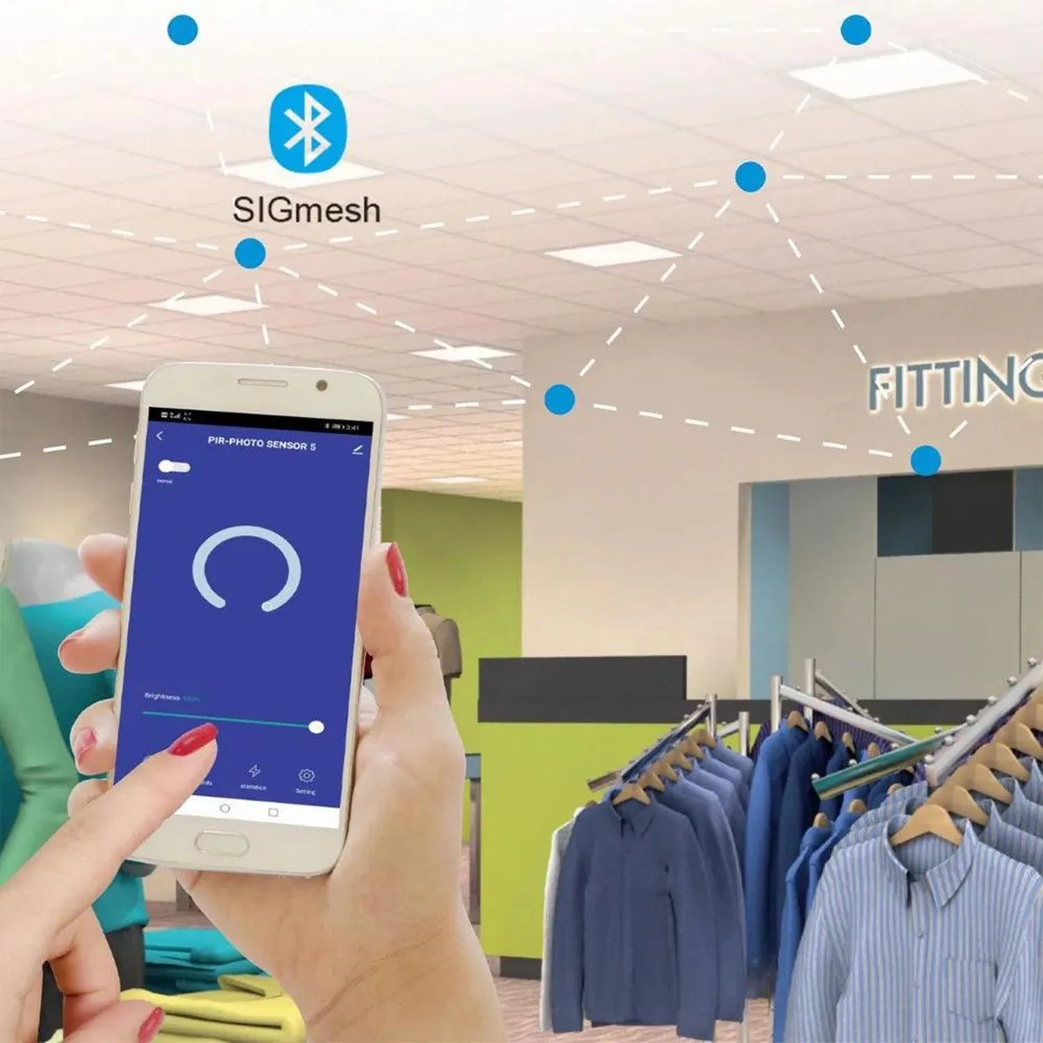 Hand holding smartphone with blue app interface displaying PIR motion sensor control in retail clothing store with SIGmesh ne