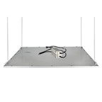 Underside view of rectangular metal LED panel with four suspension cables attached at corners and power cord coiled on surfac