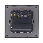 Rear view of electrical switch showing internal mechanism with brass terminals and black plastic housing mounted on gray back