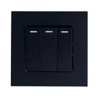 Black 3-gang 2-way light switch with illuminated rocker switches against matching black wall plate.