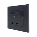 Black wall-mounted electrical socket outlet with USB ports and switch, shown installed against white background.