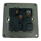 Rear view of 13A switched socket showing internal wiring terminals and brass contact points on gray backing plate.