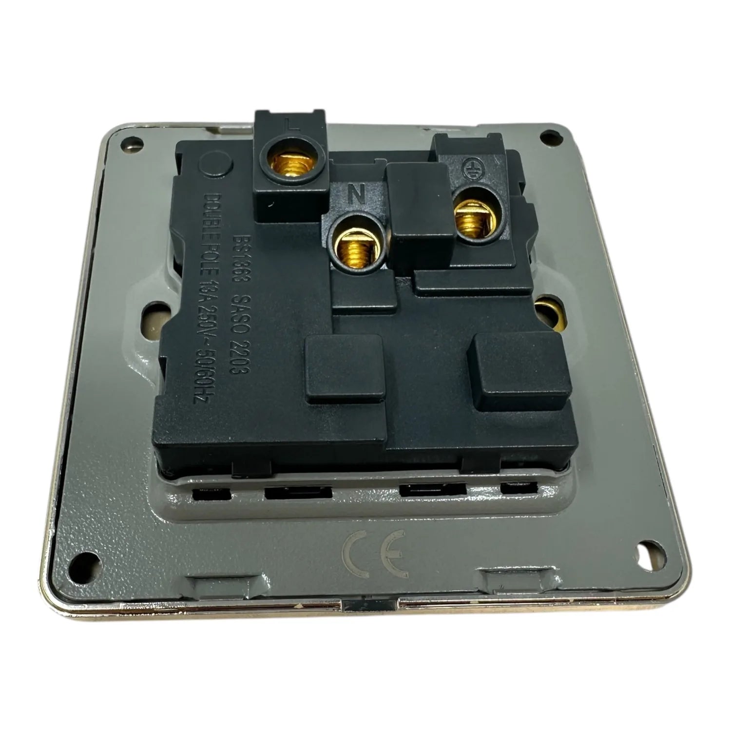 Brushed gold single switched socket with black internal mechanism and brass terminals, viewed from above showing internal com