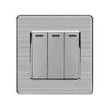 Three-gang two-way light switch with brushed stainless steel finish and black rocker switches on textured silver faceplate.
