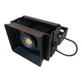 Black rectangular LED flood light with COB lamp, aluminum heat sink, and attached power cord, angled product view.
