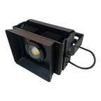 Black rectangular LED flood light with COB lamp, aluminum heat sink, and attached power cord, angled product view.