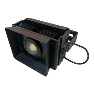 Black rectangular LED flood light with COB lamp, aluminum heat sink, and attached power cord, angled product view.