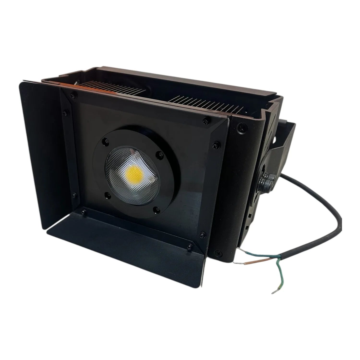 Black rectangular LED flood light with barn doors, yellow COB light source visible, power cable attached, product shot on whi