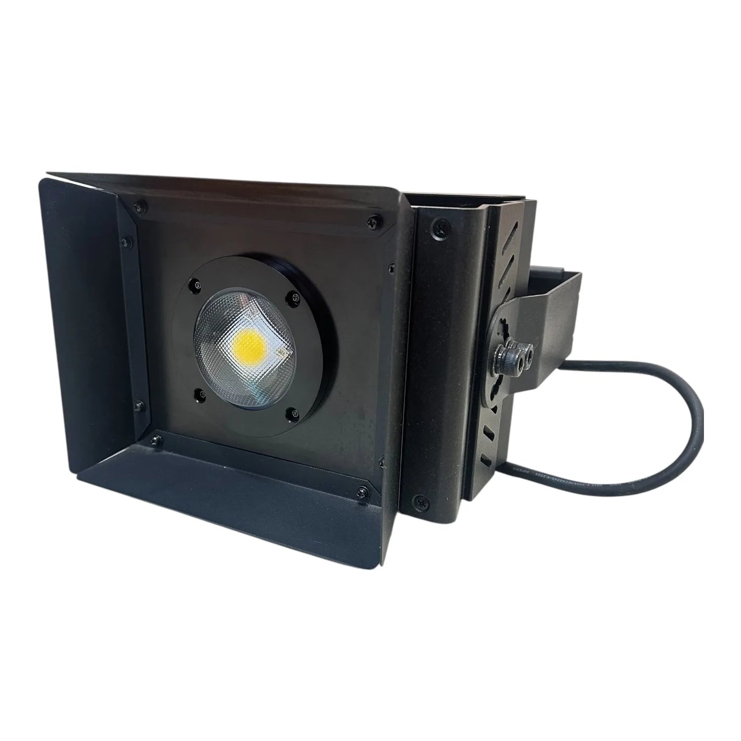 Black LED flood light with yellow-centered lamp, adjustable barn doors, and power cable against white background
